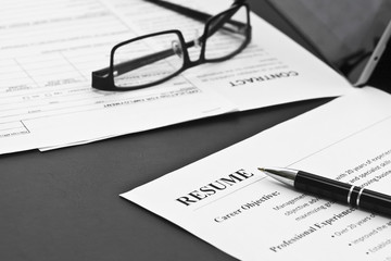 Closeup of Resume with Pen and Glasses on the Table 