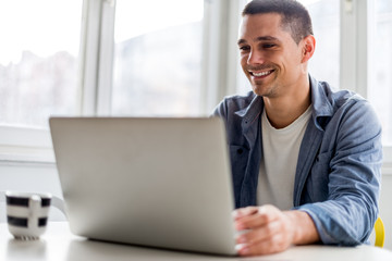 Smiling man in front of computer
