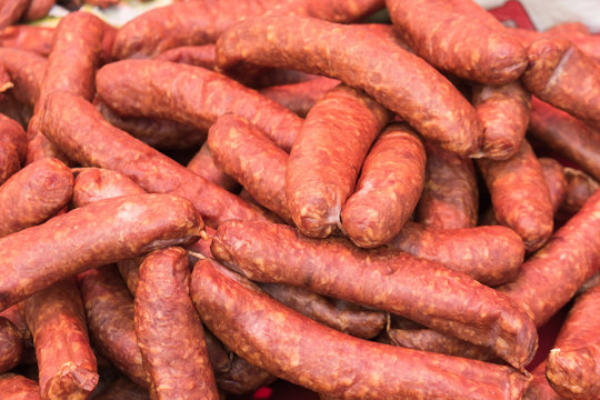 bunch of smoked spicy sausages on the market