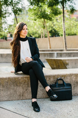 Businesswoman on concrete block