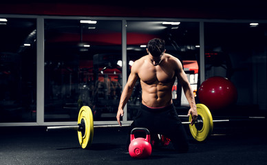 Fototapeta na wymiar Body builder gym preparing for workout. Weightlifter kettle bell.