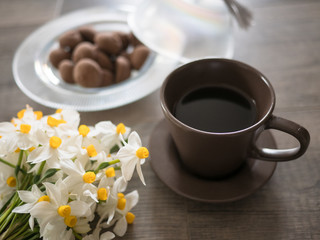 White flower,coffee and cookies on wooden