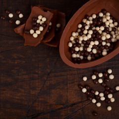 Chocolate egg for Easter on wooden background
