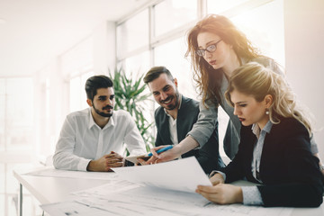 Business people and architects collaborating on project