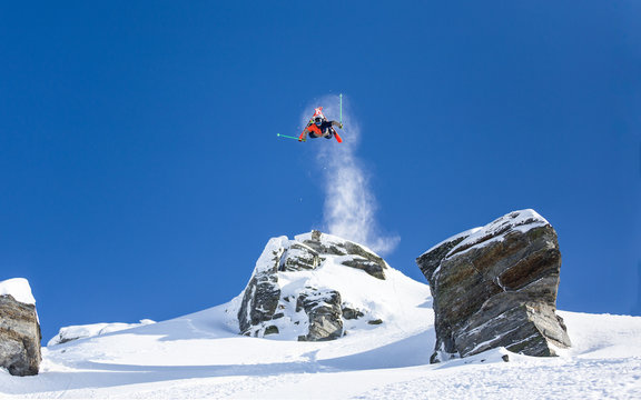 Skier backflip off a cliff
