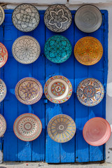 Traditional Moroccan plates displayed on a blue door