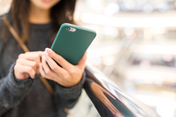 Woman sending sms on smart phone