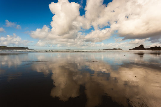 A reflective beach with clouds © Harrison