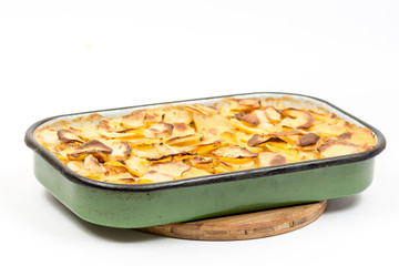 Mousaka on the kitchen wooden board isolated over white