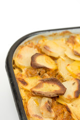 Mousaka on the kitchen wooden board isolated over white
