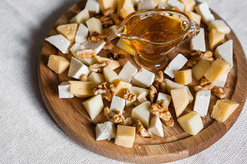 Sliced cheeses with honey and nuts