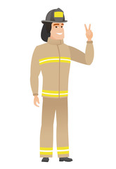 Caucasian firefighter showing the victory gesture.