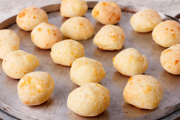 Brazilian snack cheese bread (pao de queijo) on oven-tray