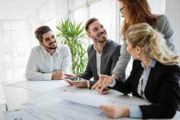 Business people and architects collaborating on project