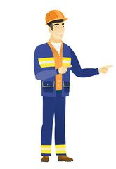 Young asian builder pointing to the side.