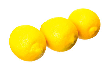 Three ripe yellow lemons in row
