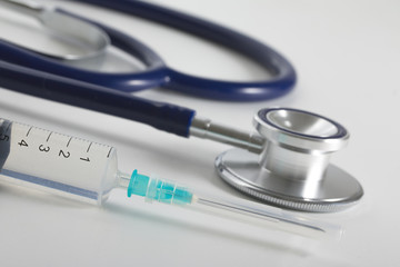 Abstract medical composition. There are syringe with medicine and stethoscope.