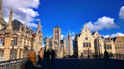 Fototapeta na wymiar Gent, Belgium. The historic center of Ghent, Picturesque medieval buildings around Korenmarkt square ( Saint Nicholas' Church, The Celtic Towers,... ) overlooking the Leie river in Ghent town, Belgium