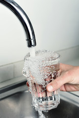 man filling a glass of tap water © nito