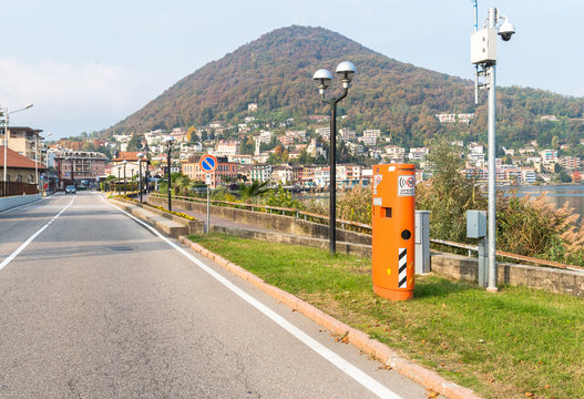 Pavement mounted Speed control device hidden inside the orange box, situated in urban areas of Italy.
