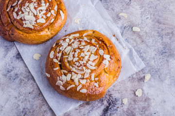 Almond  croissant for breakfast. Roll pastry with nut on table background. Copy space