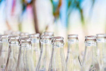 selective focus of empty bottle over blurred garden background.