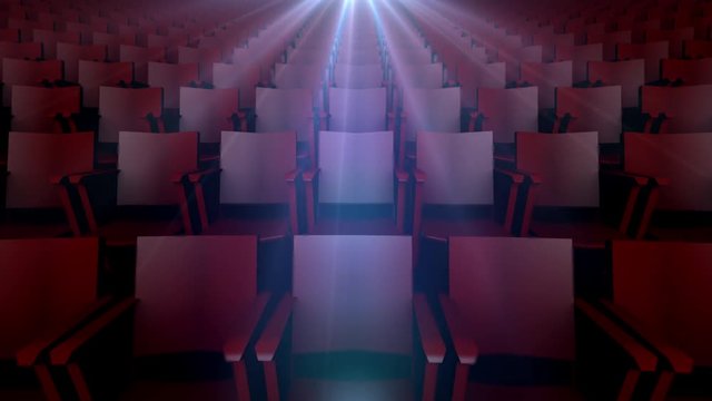 Rows of Movie Seats with Light of Projection Above. rows of empty movie seats with light of a projector flashing above with lens flare
