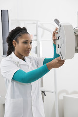 Young Female Doctor Operating X-ray Machine In Hospital