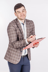 young business man standing and writing in folder on a white background.