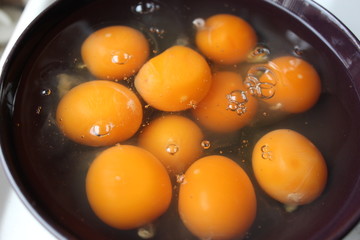raw eggs in a black plate