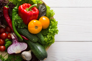 Border of fresh vegetables on wooden background with copy space