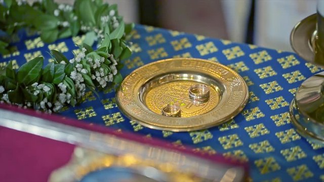 wedding rings on a wedding ceremony in the church on table