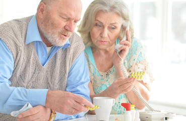 Elderly couple with pills