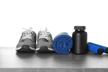 Sports concept. Workout objects on grey table and white background