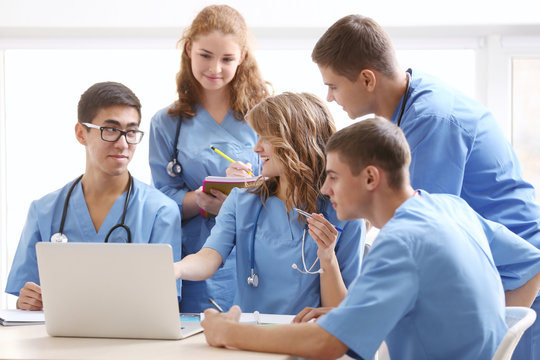 Group of medical students having lecture indoors