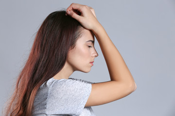 Fototapeta premium Depressed young woman on color background
