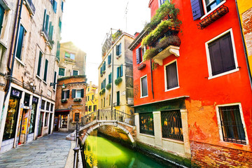 Fototapeta na wymiar View of the colorful Venetian houses with bridges across on the canal in Venice