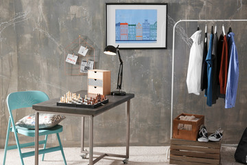 Interior of a teenage boy's room with chess on a table