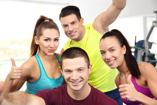 Group of people taking selfie in gym