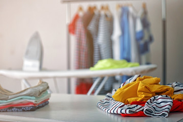 Clean clothes on table at home