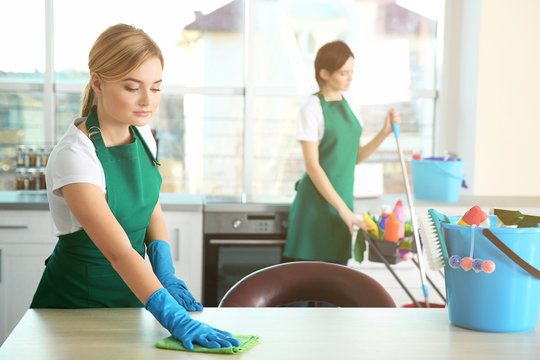 Woman cleaning kitchen table