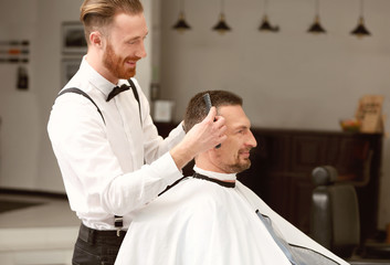 Barber making modern male hairstyle