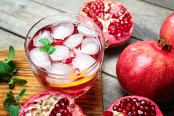 Glass of cold fruit cocktail on wooden board