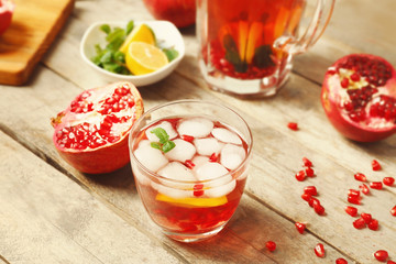 Glass of cold fruit cocktail on wooden table