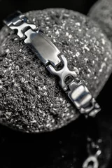 Fotobehang Silver bracelet on stone © respow