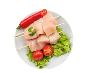 Raw chicken meat with vegetables on white background