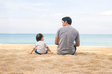 Father and daughter playing at beach. Healthy father and daughter playing together at the beach carefree happy fun smiling lifestyle.