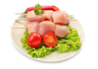 Raw chicken meat with vegetables on white background