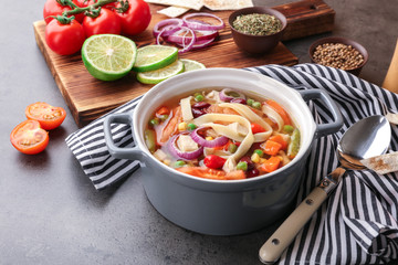 Chicken tortilla soup with vegetables on table