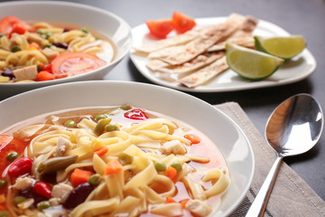 Chicken tortilla soup in plate on kitchen table